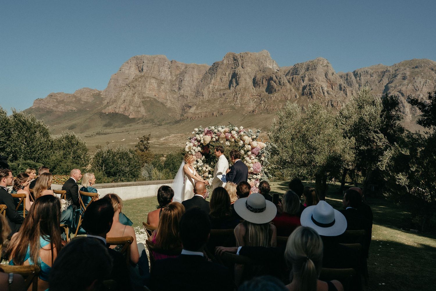 A panoramic sequence of scenic mountain views and wedding guests celebrating in a desert landscape setting.