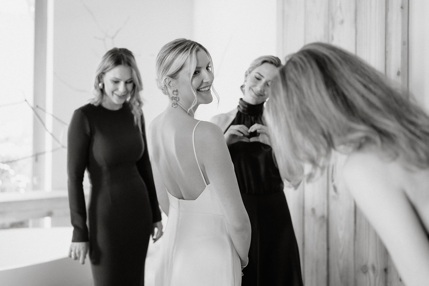 A series of black and white portraits showing different poses and expressions in a bright studio setting.