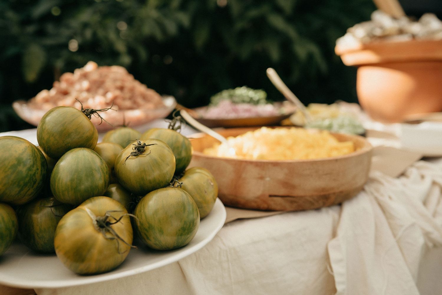 Fresh fruits and homemade dishes displayed on a rustic wooden table for a family gathering.