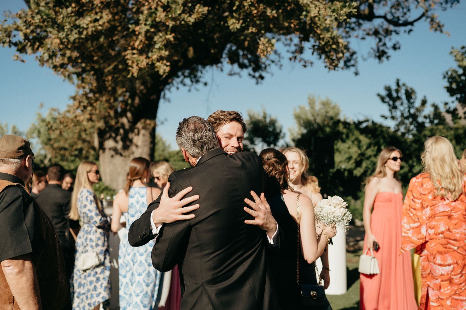 A collage of outdoor wedding celebration photos showing guests dancing and socializing under trees in natural lighting.