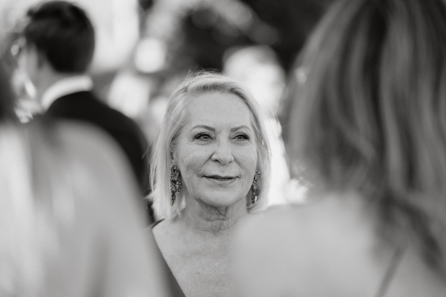 Black and white wedding photography collage showing candid emotional moments and joyful expressions at a celebration.