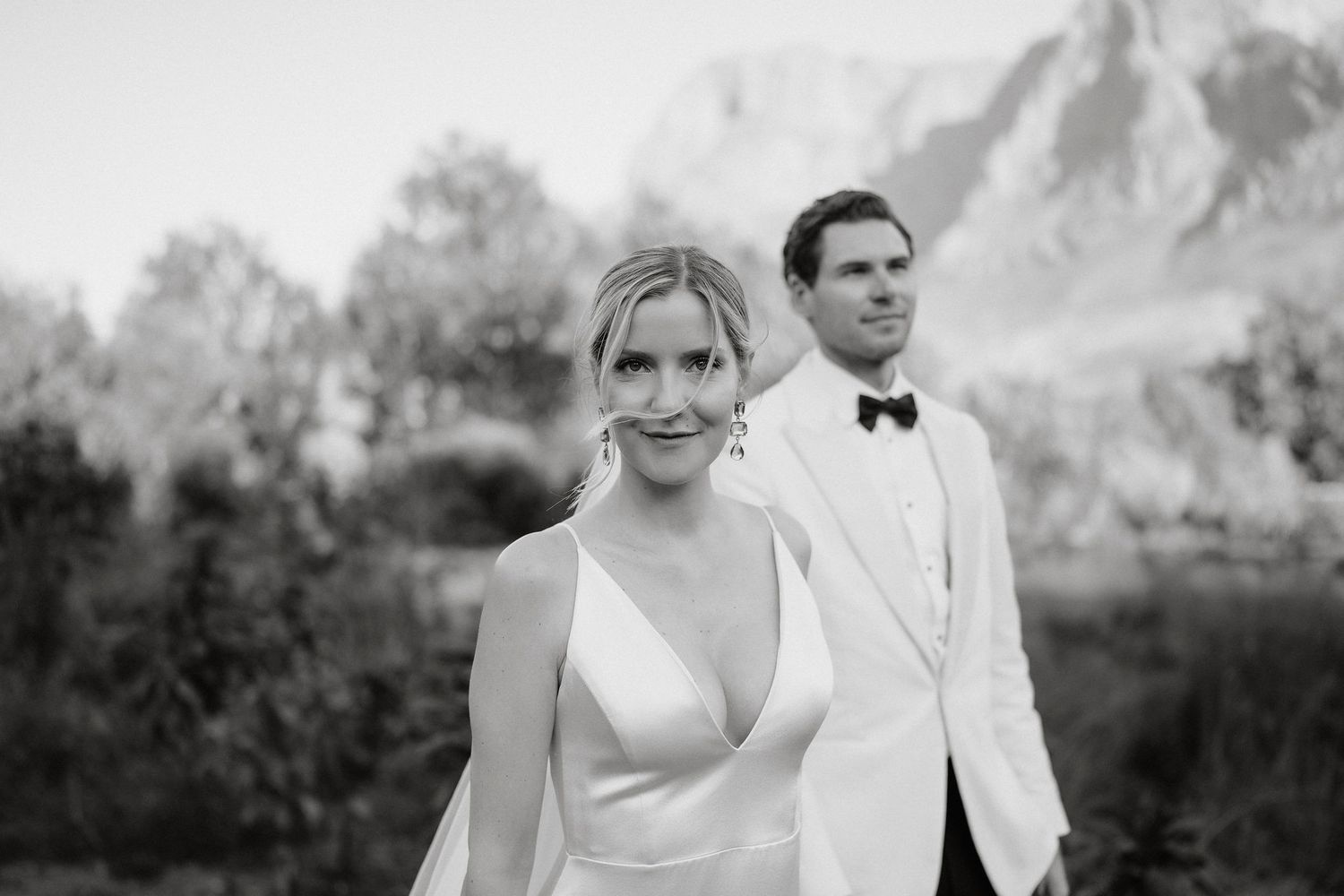 A romantic wedding photo session with mountains and desert landscape in the background.
