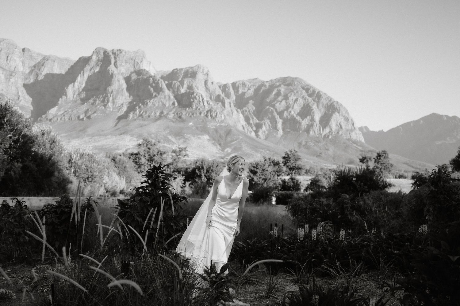 A series of seven black and white landscape photographs showing mountains and valleys in a panoramic view.