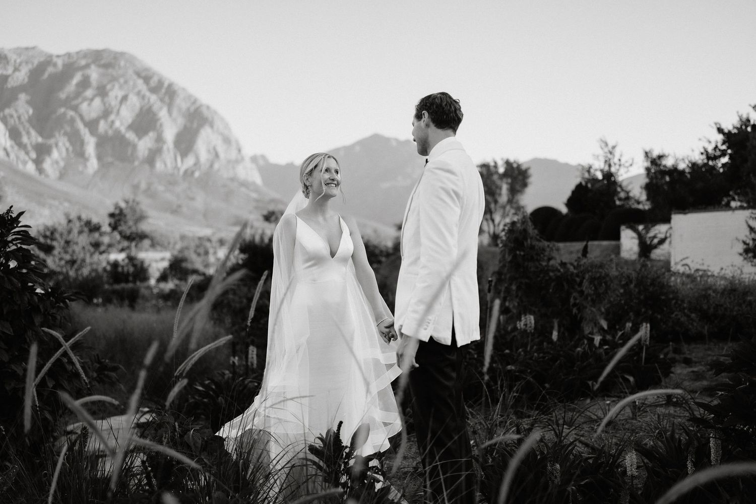 Black and white wedding photos showing couples in outdoor settings with mountain landscapes and natural scenery.