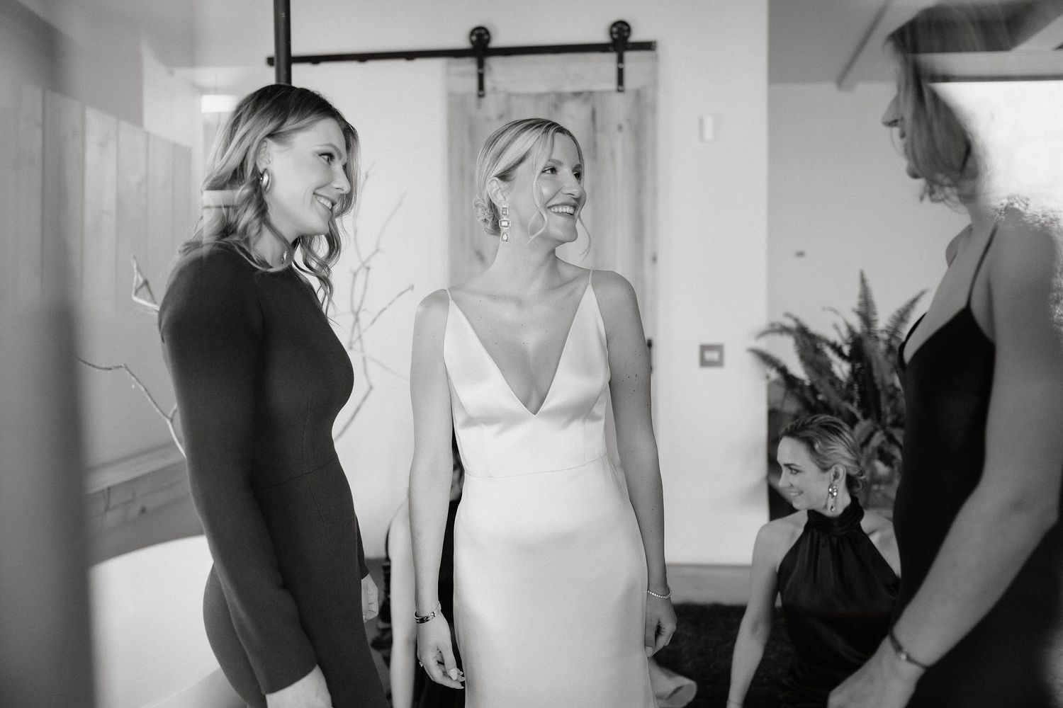A series of black and white candid photos showing a woman in a white dress getting ready for a special occasion.