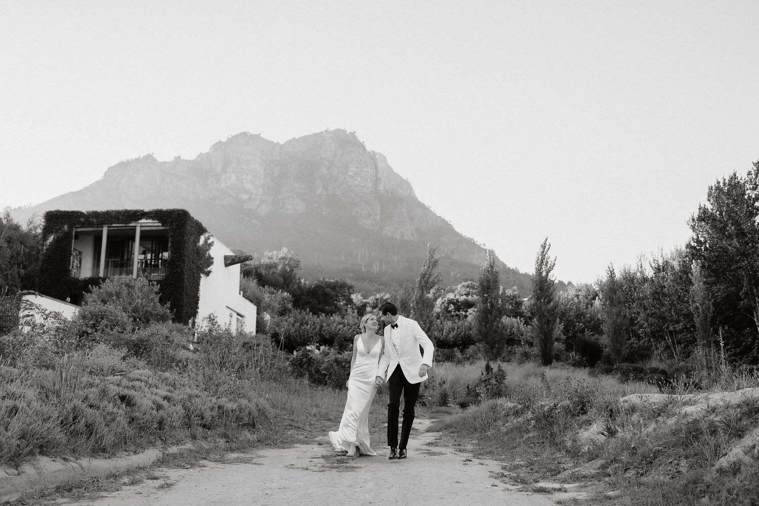 A series of black and white landscape photographs showing mountains, buildings and rural scenery in a panoramic view.