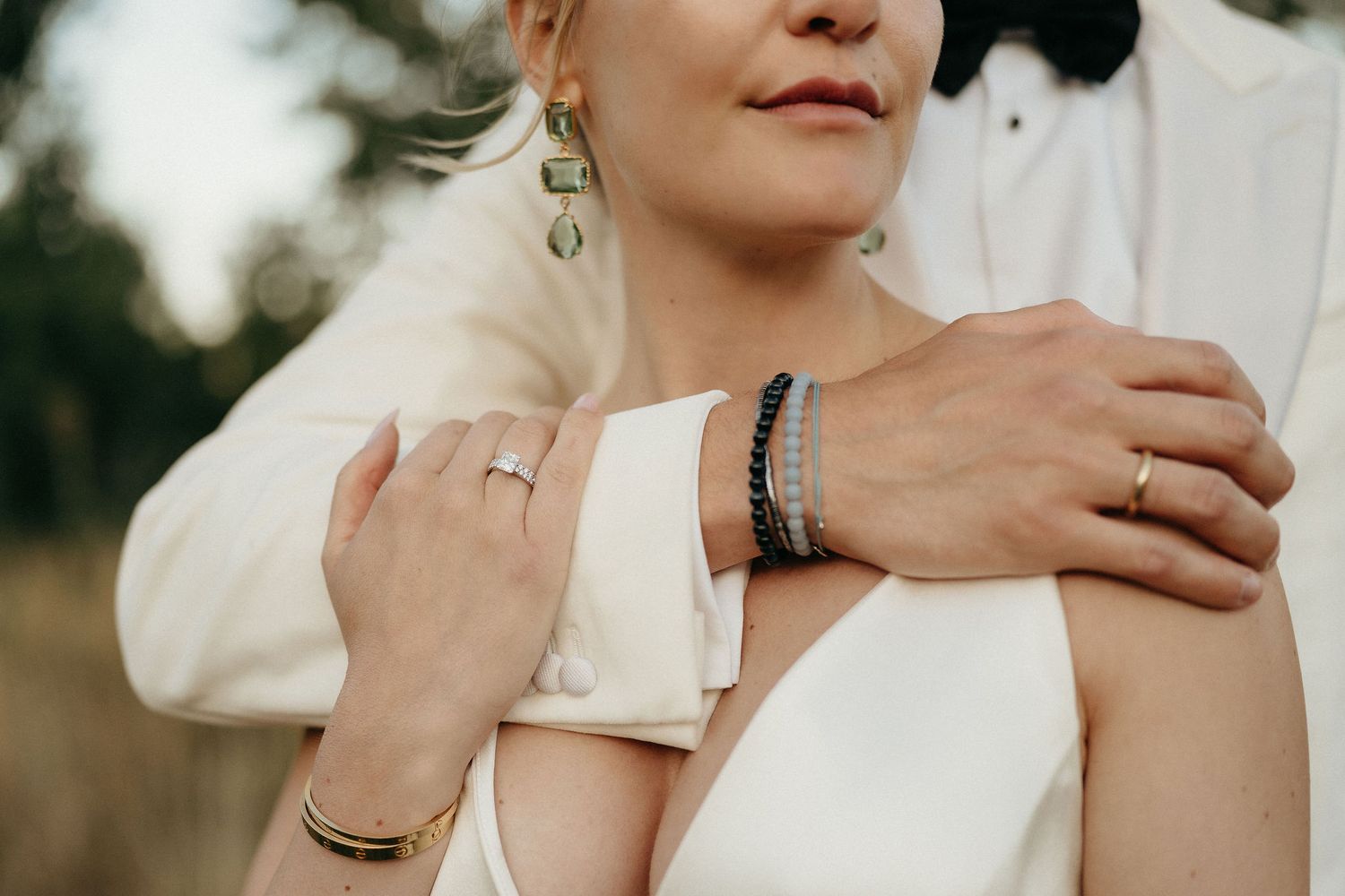 A collection of wedding photos showing hands with rings and romantic moments in white attire against soft backgrounds.