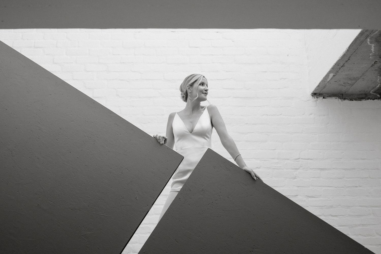 A black and white photo montage shows multiple artistic portraits of someone posing against dramatic backgrounds.