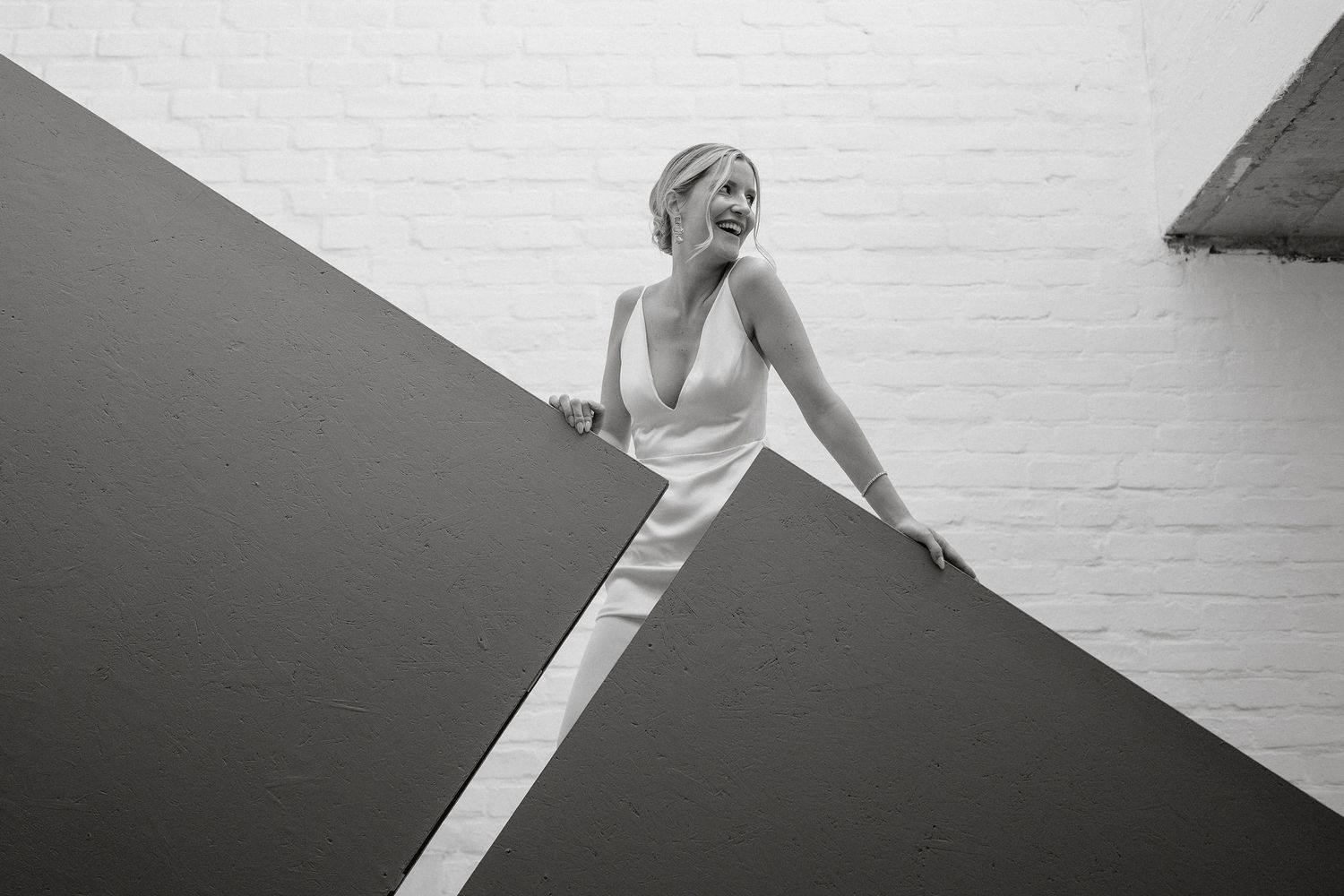 A black and white fashion photo series shows a model in various elegant poses against a white backdrop.