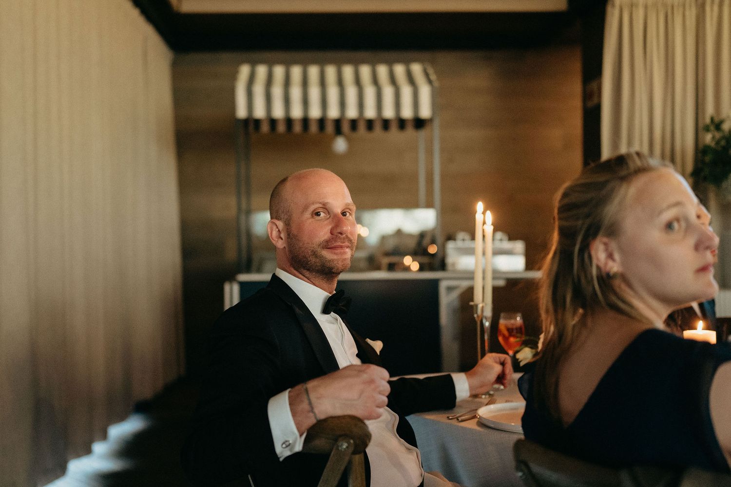 Guests enjoying cocktails and conversation at an elegant evening event.