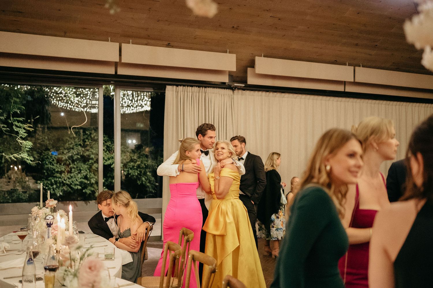 A collage of wedding reception moments showing guests dancing and celebrating in an indoor venue.