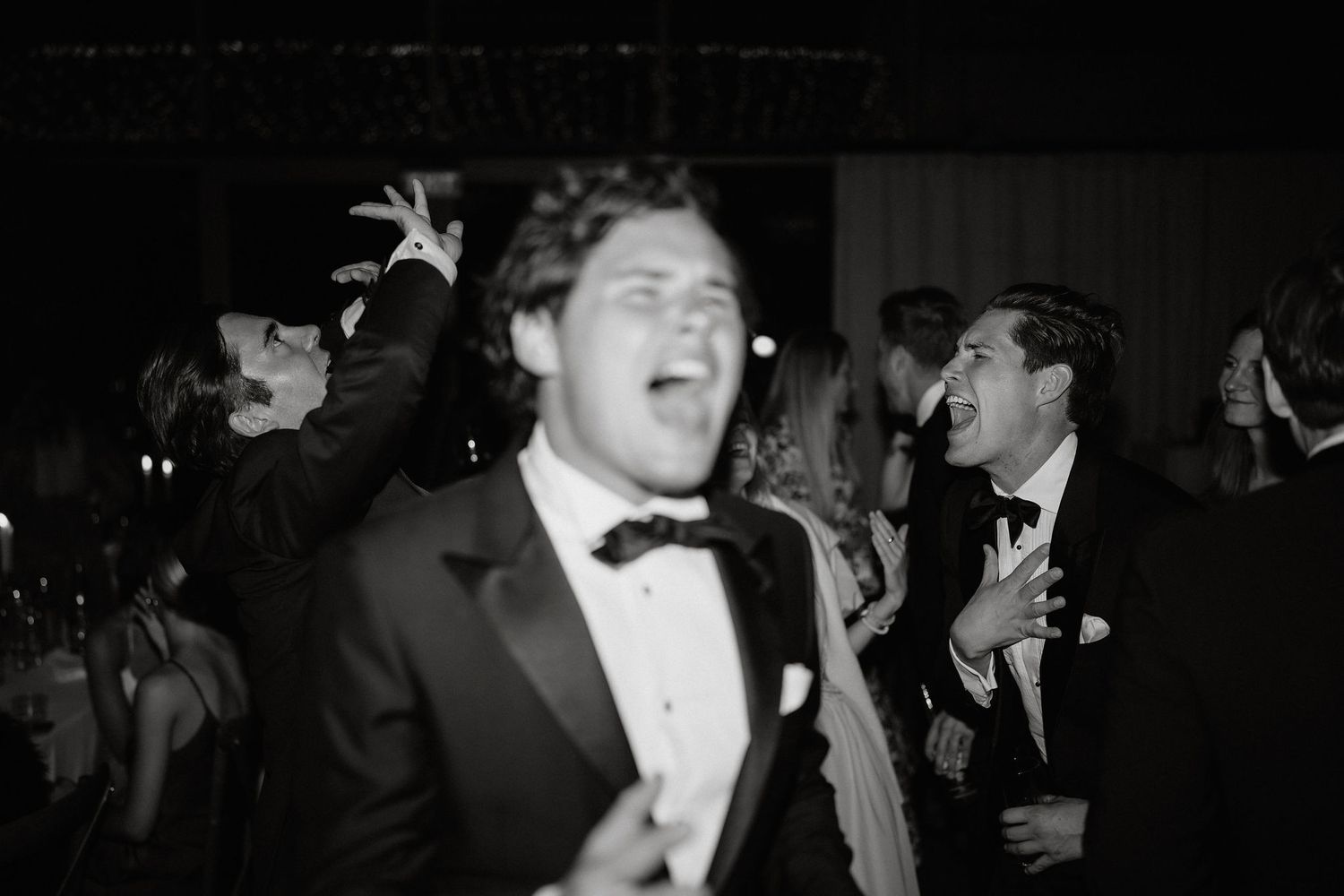 A black and white photo collage showing people dancing and socializing at what appears to be a formal event.