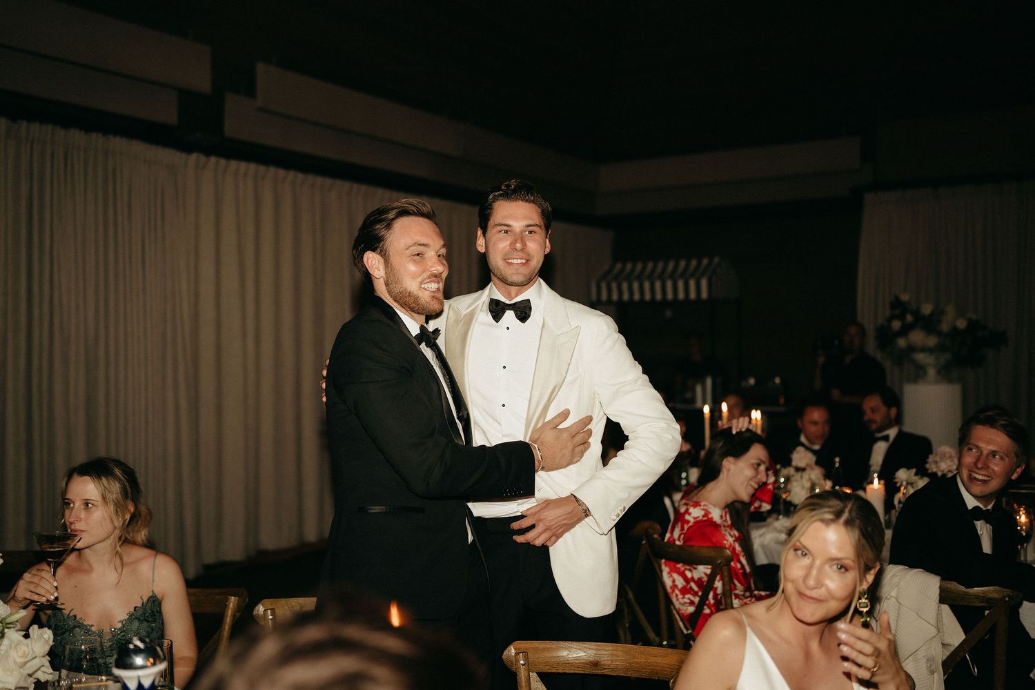 A wedding reception dance floor filled with guests enjoying themselves in an elegant indoor venue.