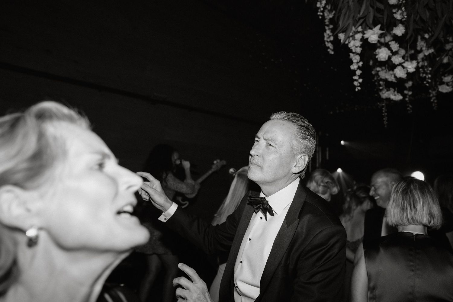 A black and white photo collage shows intimate moments from what appears to be a wedding celebration.