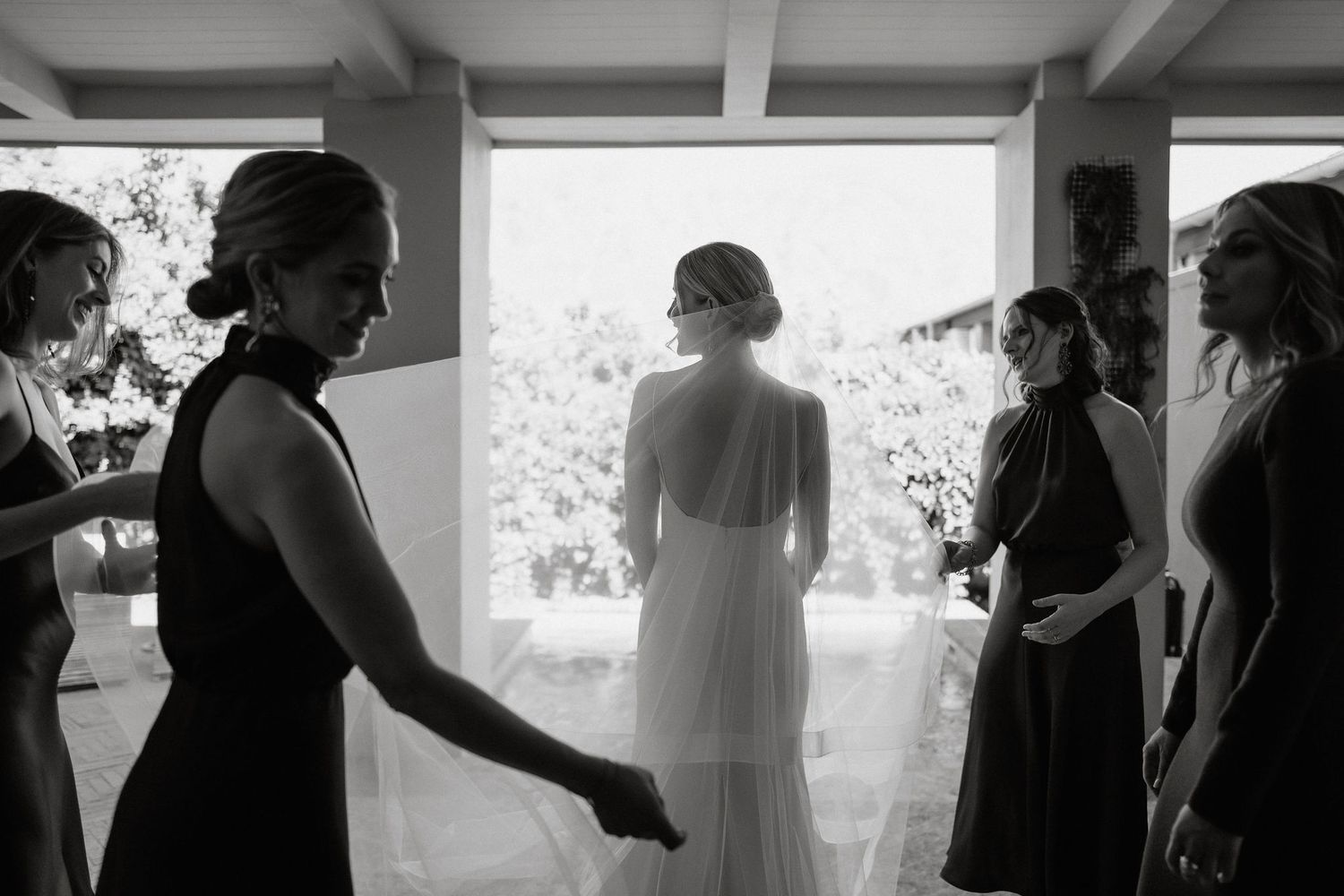 A sequence of black and white wedding preparation photos showing intimate moments between people getting ready for the ceremony.