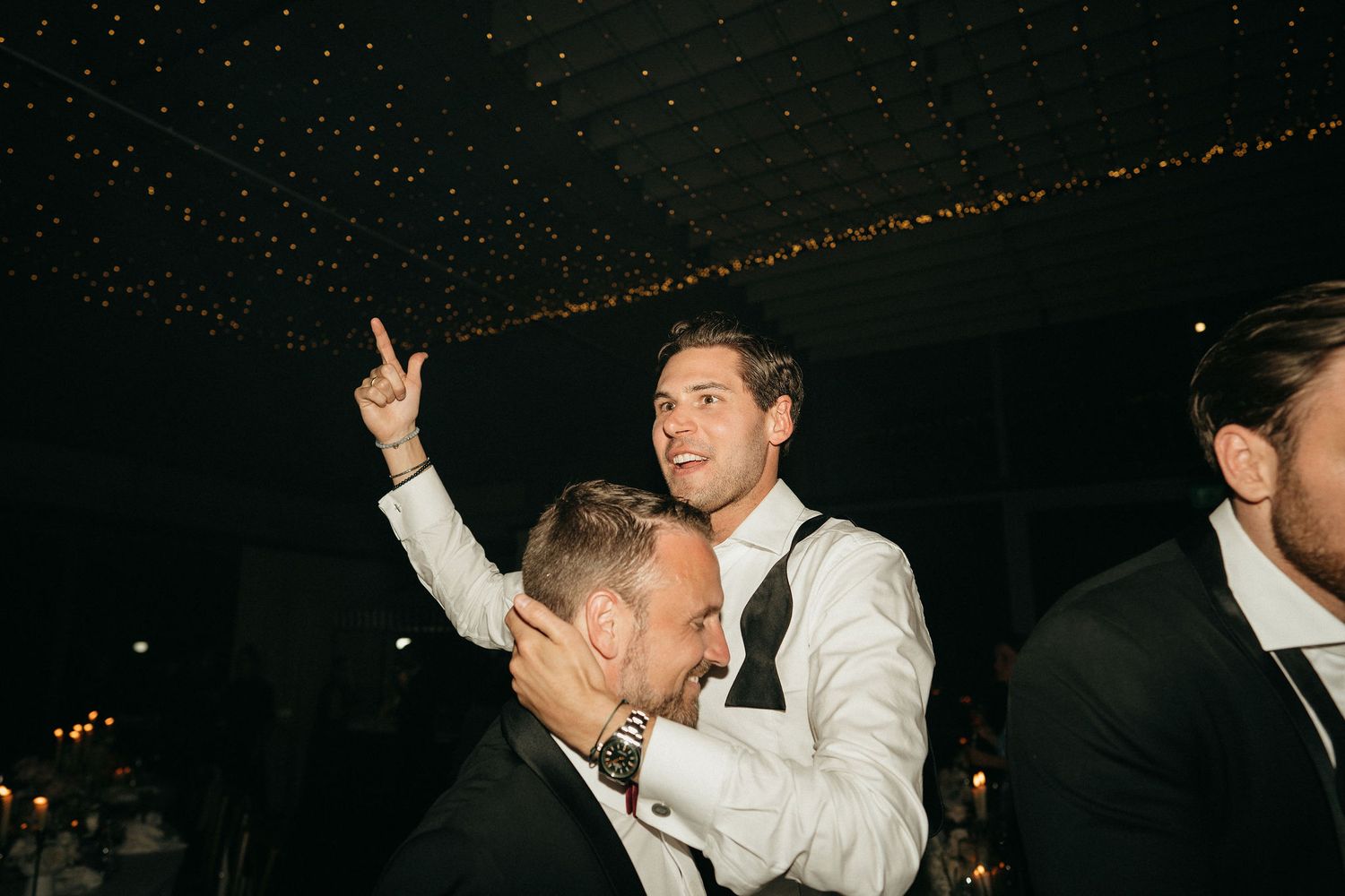 A series of black and white party photos showing people dancing and celebrating at a festive nighttime event.