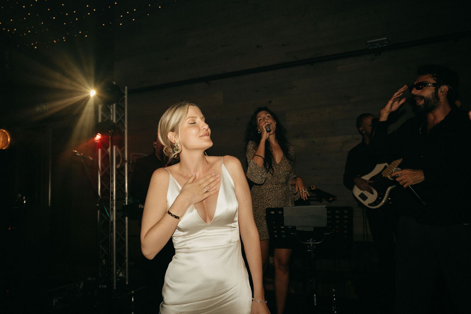 A sequence of dark nightclub photos showing a person in a white top dancing and enjoying themselves on the dance floor.