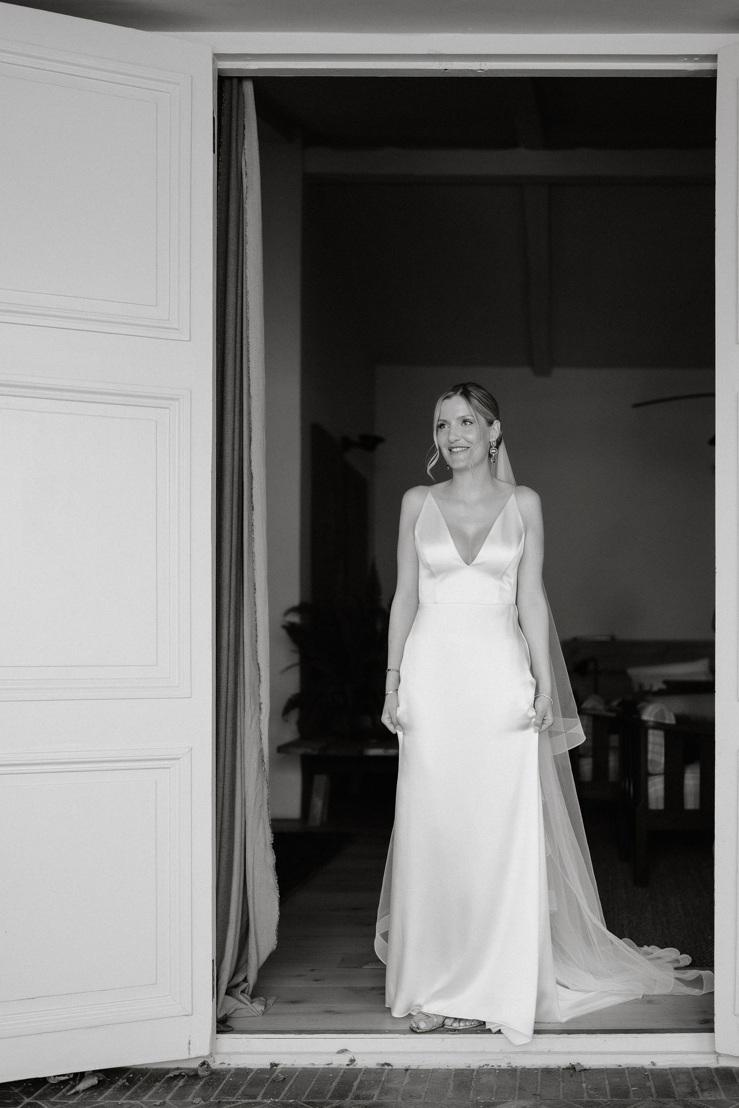 A series of black and white photographs showing a figure in a white wedding dress framed in doorways.