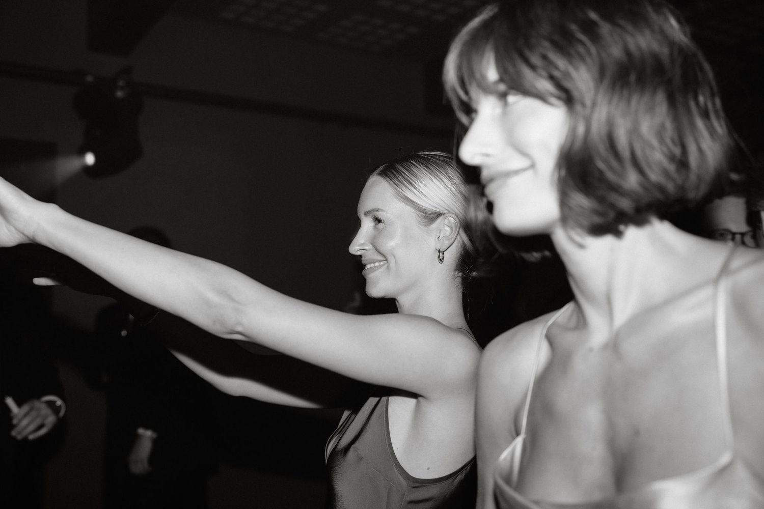 A sequence of black and white dance photos showing people moving in an energetic performance.