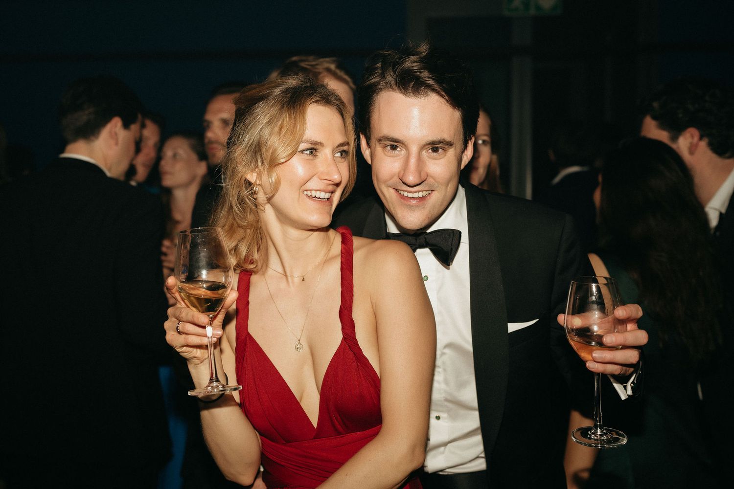 A series of candid party photos showing people in formal attire including a red dress at an elegant evening event.