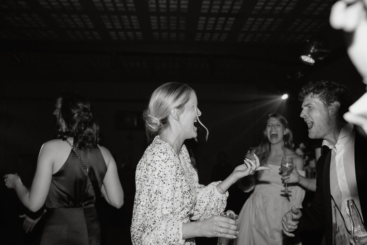 Black and white photos of people dancing at what appears to be a wedding reception or party.