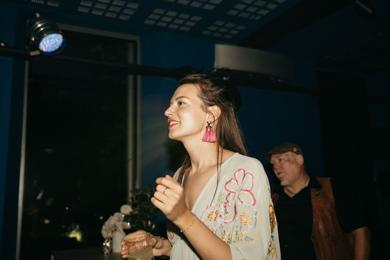 People dancing and enjoying themselves at a dimly lit nightclub or party venue.