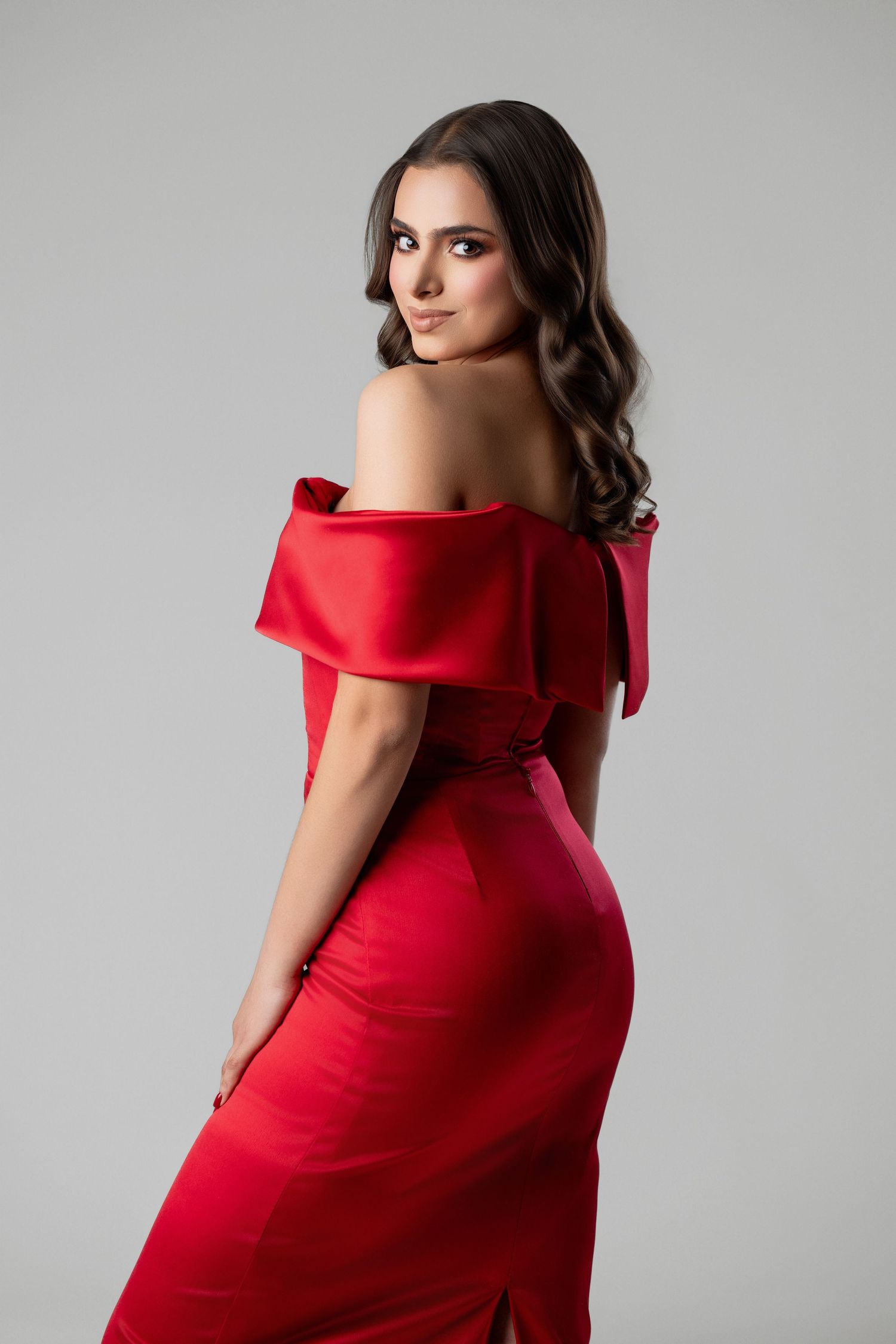 Fashion photo series featuring a red off-shoulder formal dress against a gray background.