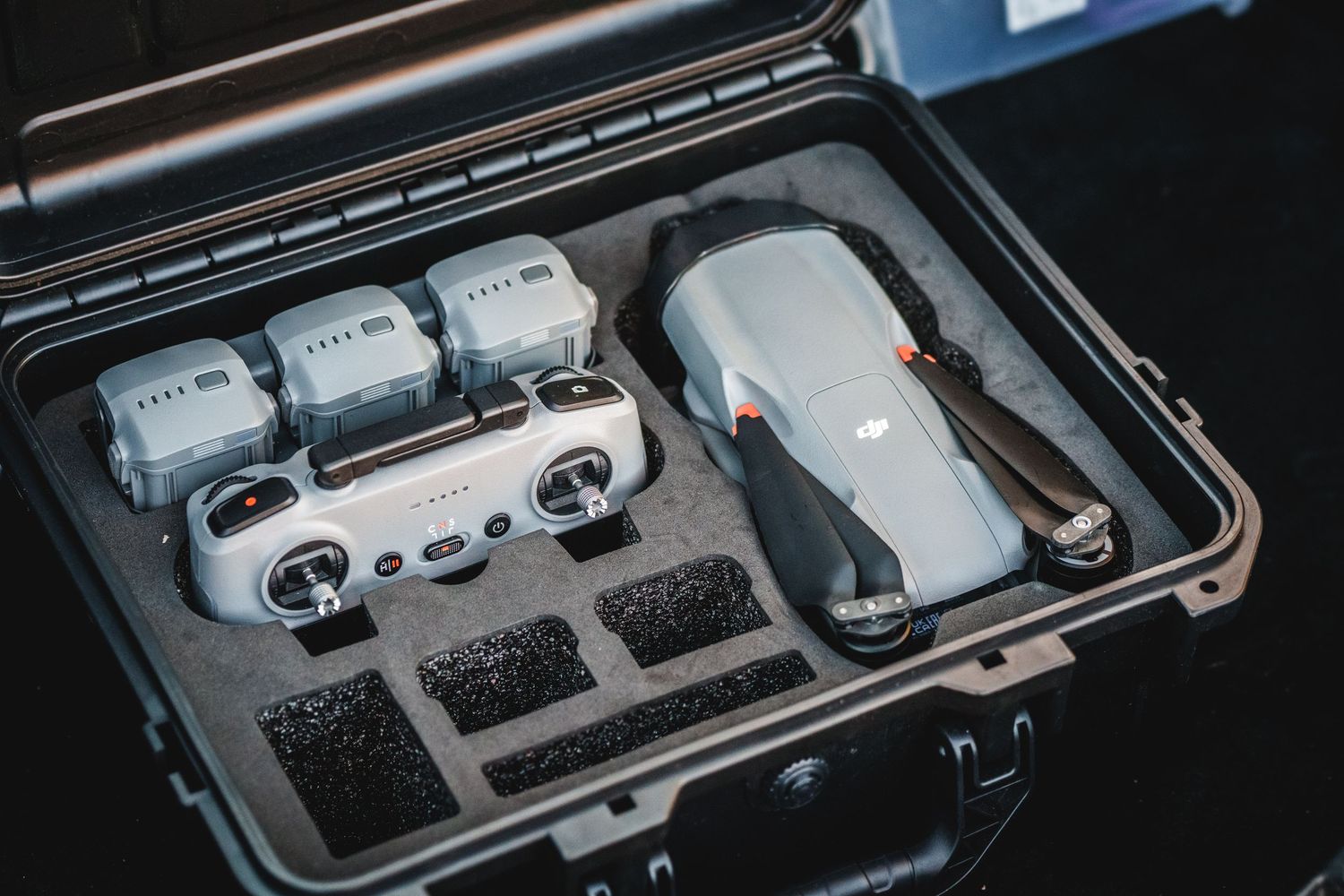 DJI Mini 2 drone and batteries neatly arranged in a protective hard case with custom foam padding.