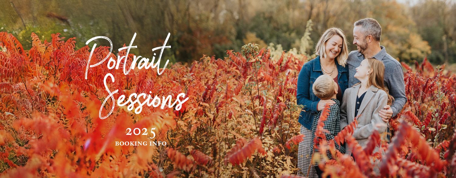 Family embraces in vibrant autumn foliage with red bushes and golden light during sunset portrait session.