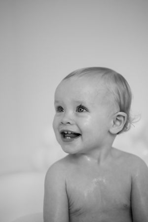 Black and white portrait series showing a baby's joyful expressions and laughter.