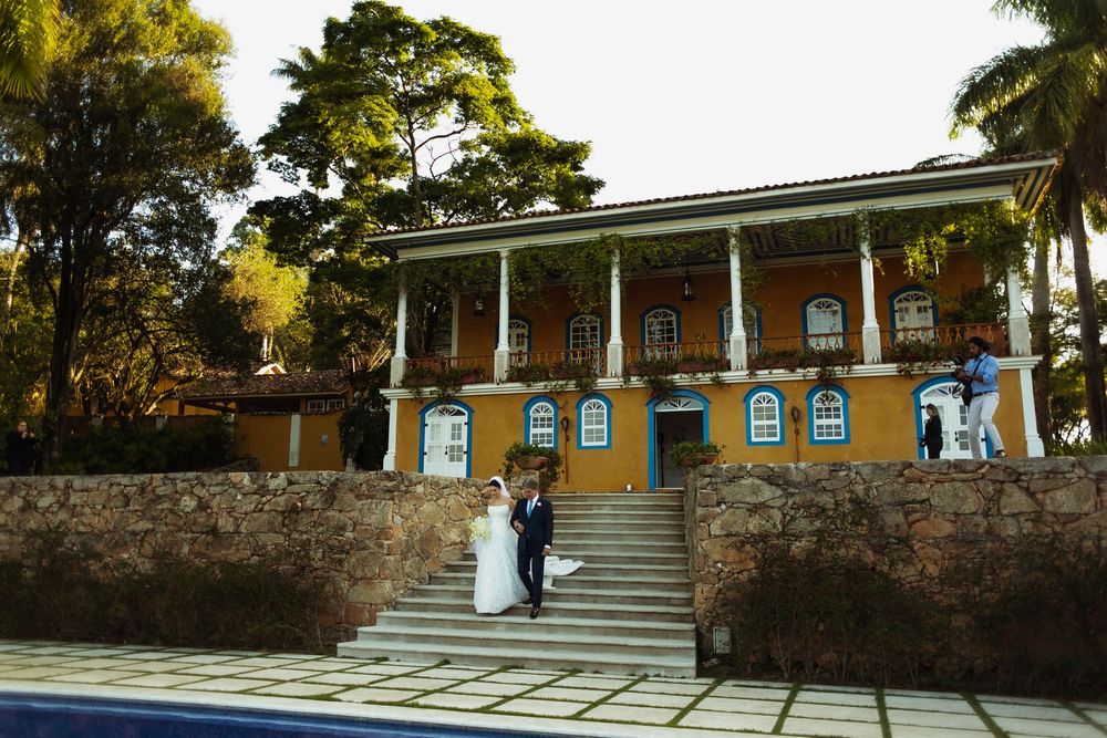 Yellow colonial-style building with white pillars and stone steps for wedding venue.