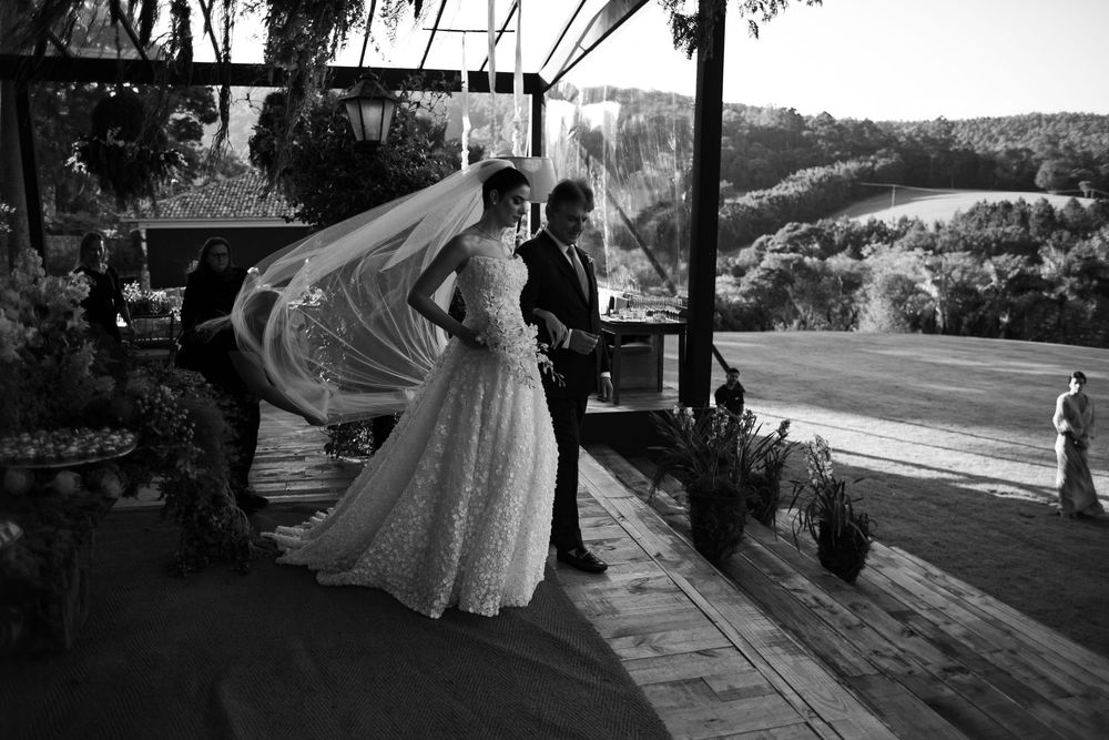 Black and white wedding photography capturing intimate moments on a scenic pathway.