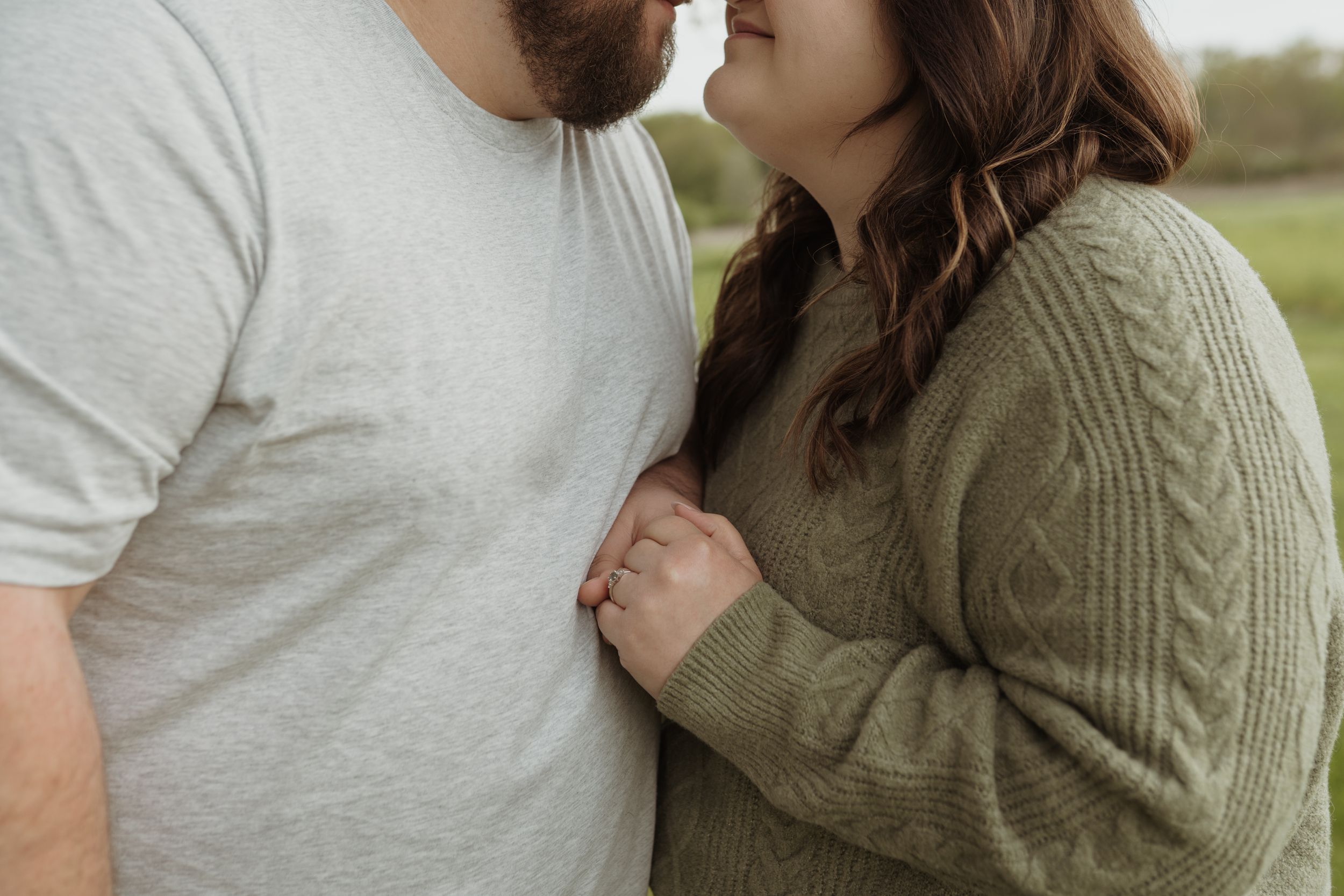 An intimate close-up of a couple sharing a romantic moment outdoors.