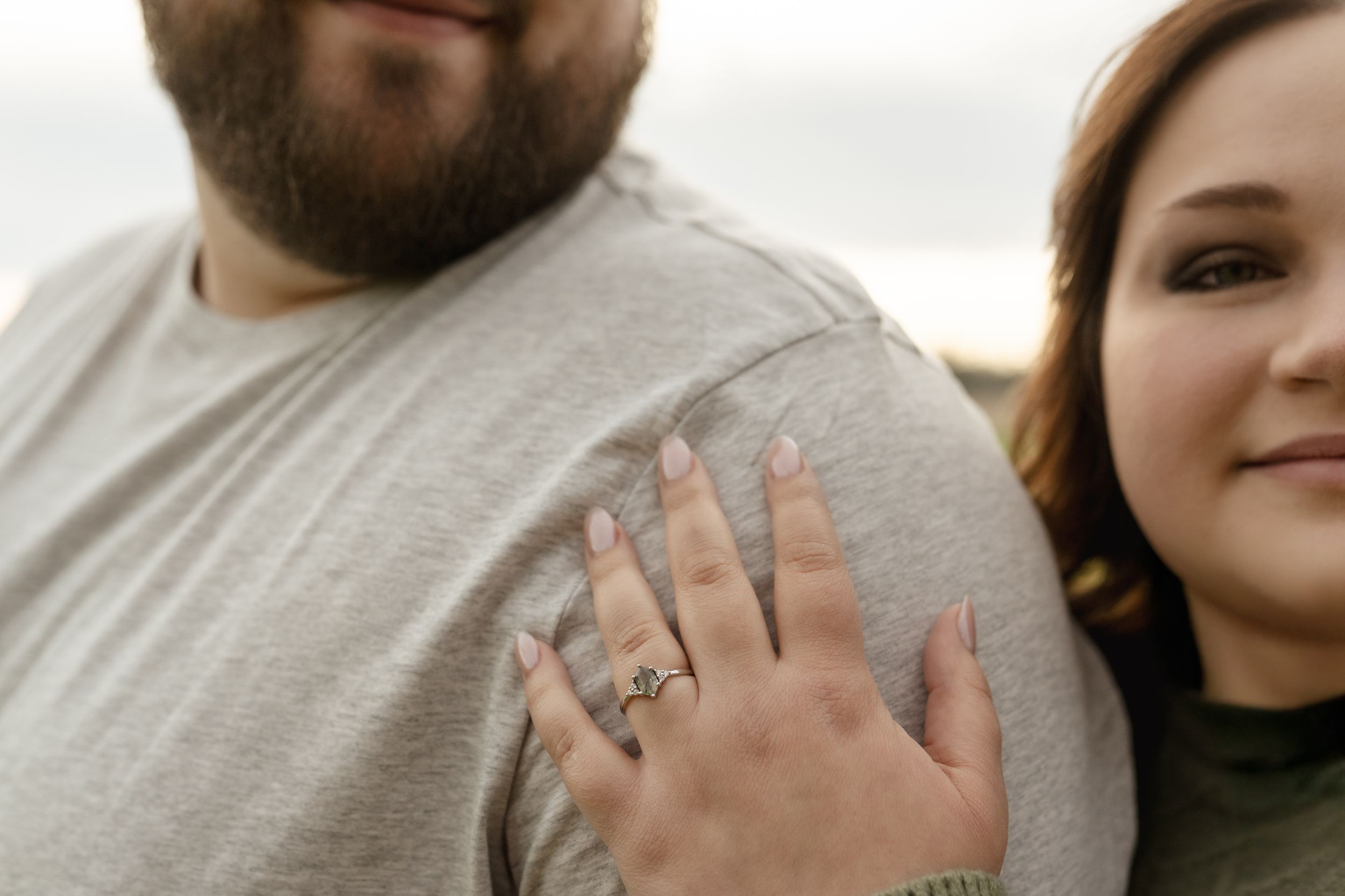 Close-up shot of a couple's intimate embrace showing gentle hand placement and affection.