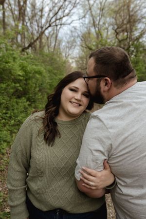 A playful and romantic couples photoshoot in a natural outdoor setting.