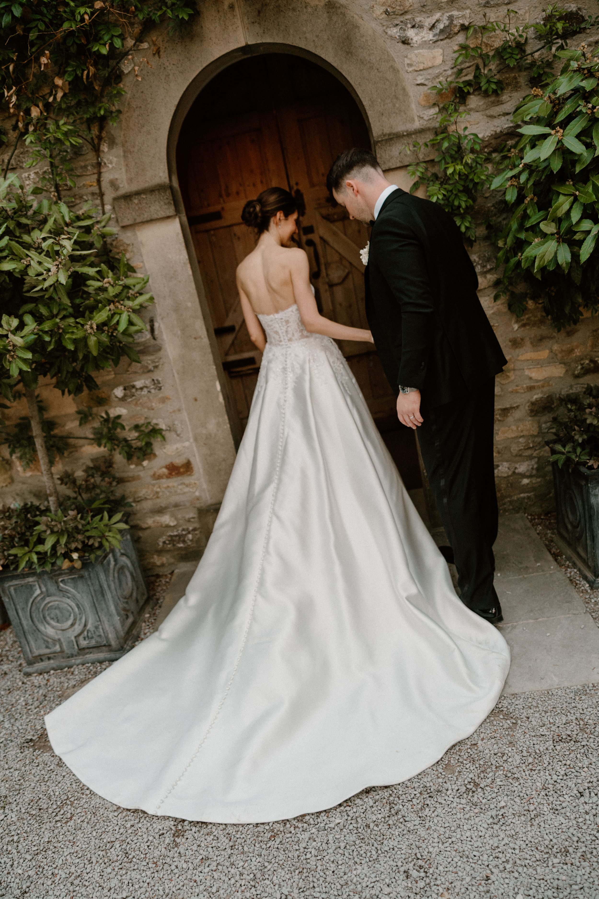 Sequence of elegant wedding shots showing flowing white wedding dress train and classic decor in a rustic venue.