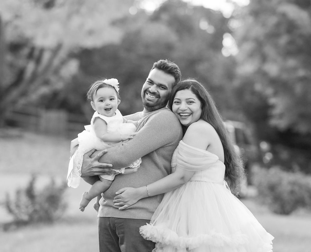 Black and white outdoor family portrait in natural setting.