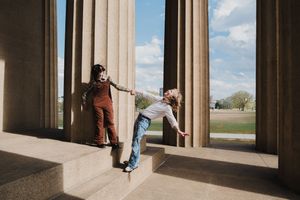 Architectural photos of colonnade with blue sky and dramatic shadows.