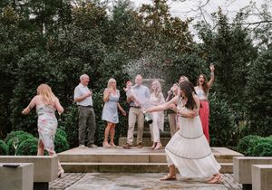 Group celebration moment captured outdoors with joyful reactions.