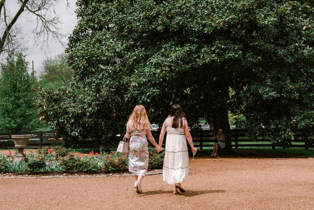 Casual outdoor garden photoshoot with natural landscaping and pathways.