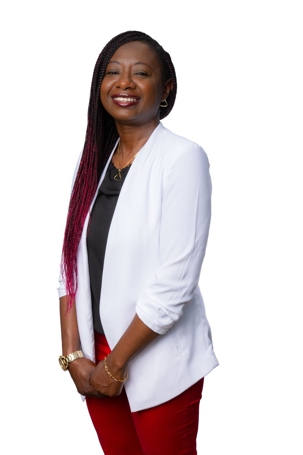 Professional portrait of someone wearing a white blazer jacket and red pants against a light-colored background.