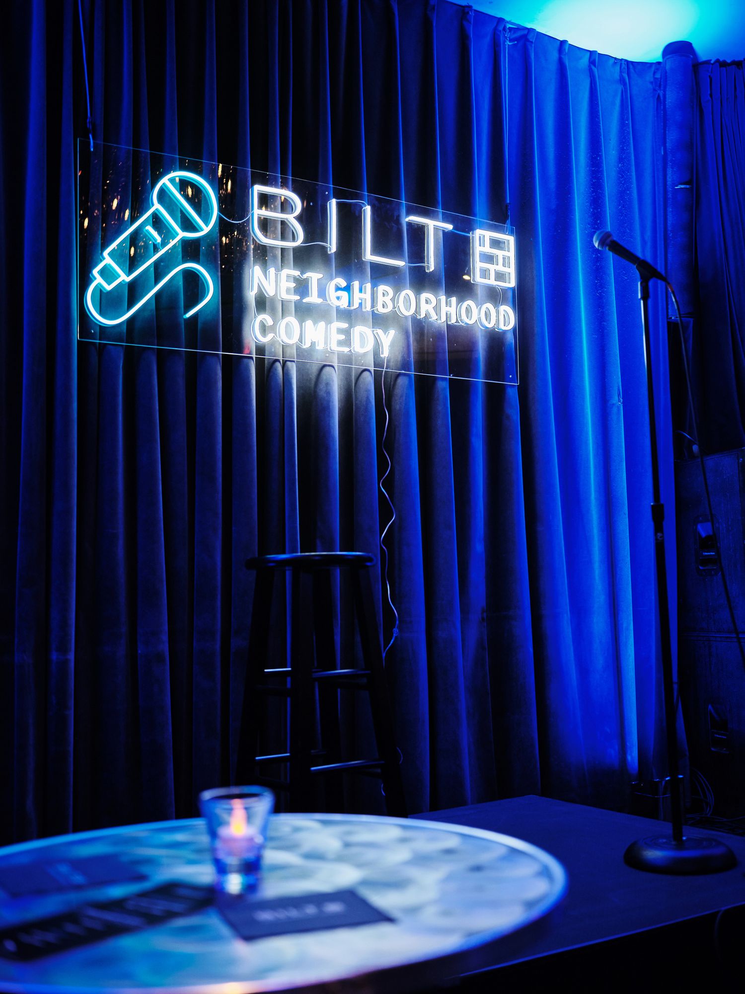 Event detail shot showing branded setup for Bilt Neighborhood Comedy show at Capo Deli DC.