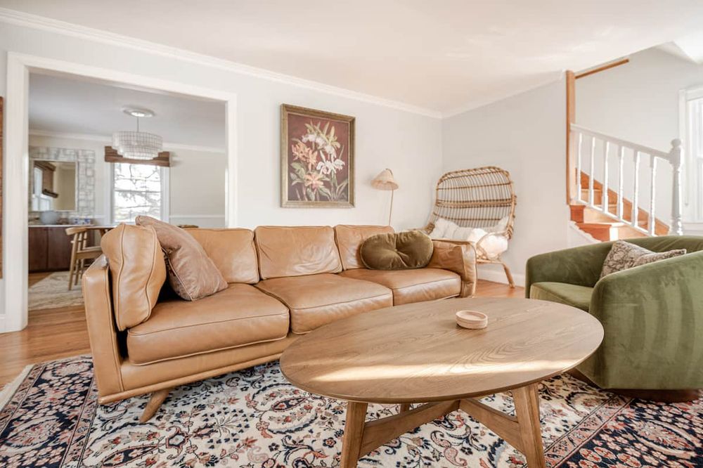 Mid-century modern living room in Frederick, MD featuring exposed wood beams and open floor plan.