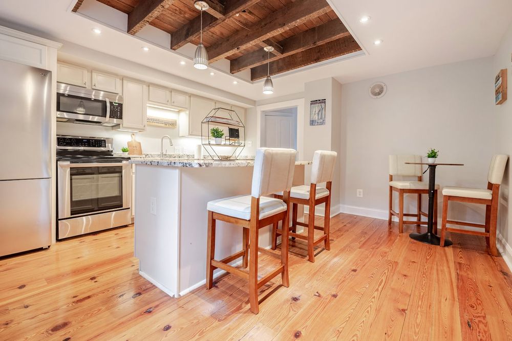 Historic Annapolis kitchen renovation featuring exposed ceiling joists and modern appliances.