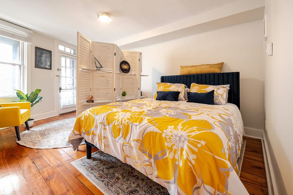 Bright and airy bedroom with large windows in Annapolis, Maryland rental listing.