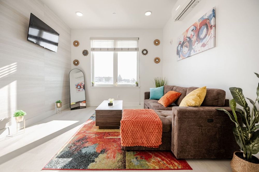 Modern open-concept apartment in Canton, Baltimore showing kitchen to living room flow.