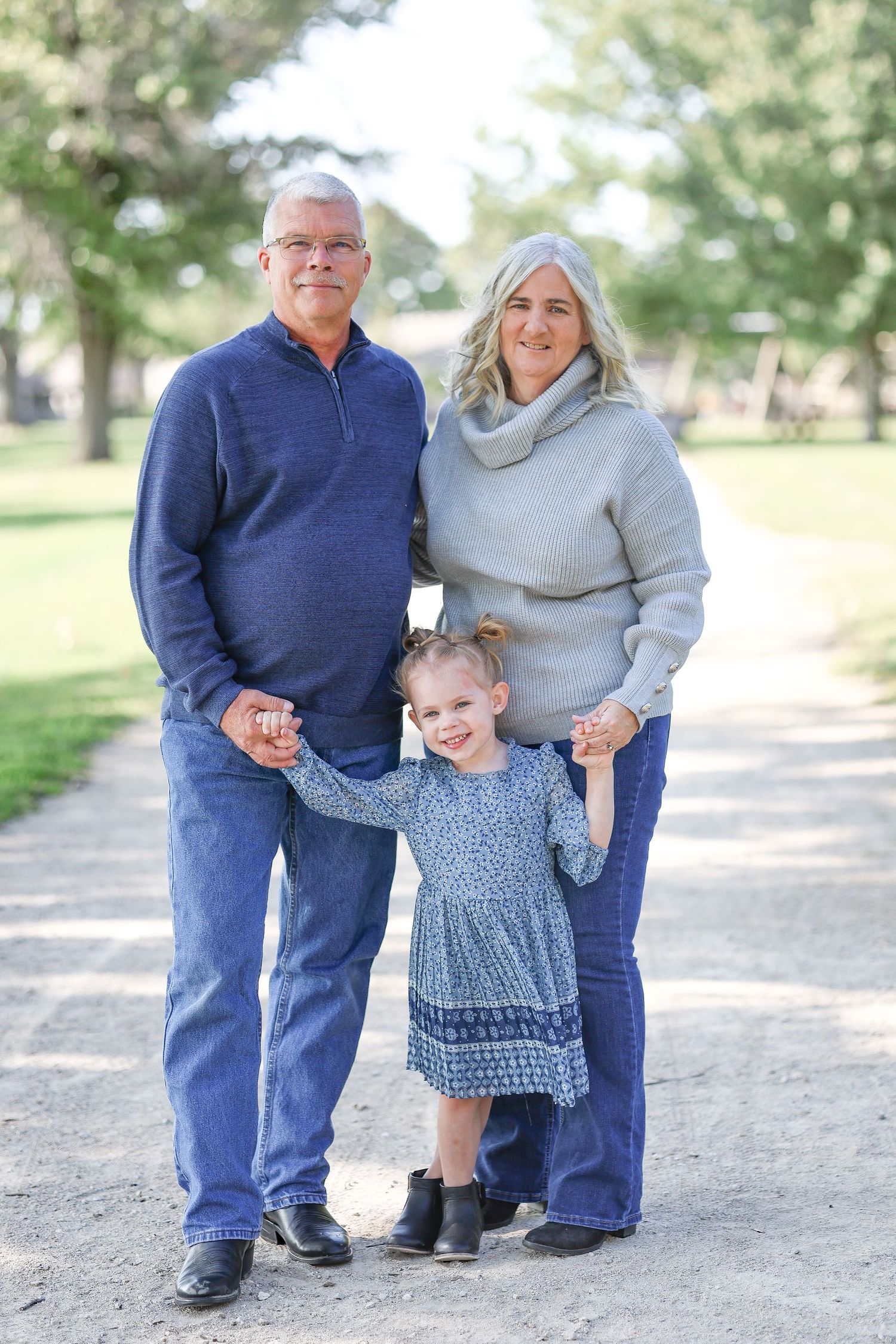 Springfield, IL family photographer captures grandparents smiling with their granddaughter during a photo session in Central, IL