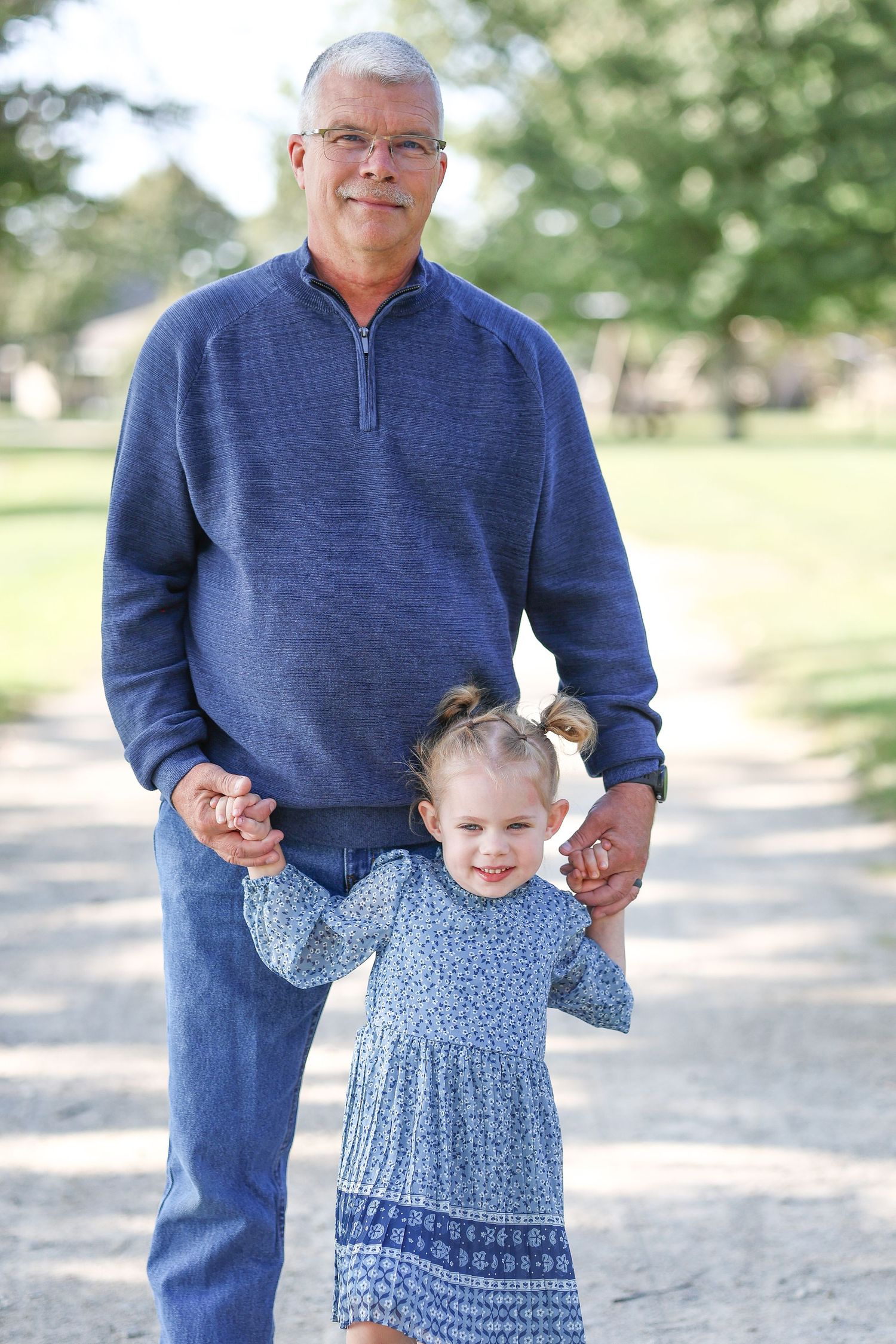 Springfield, IL family photographer captures a grandpa smiling with his granddaughter during a photo session in Central, IL