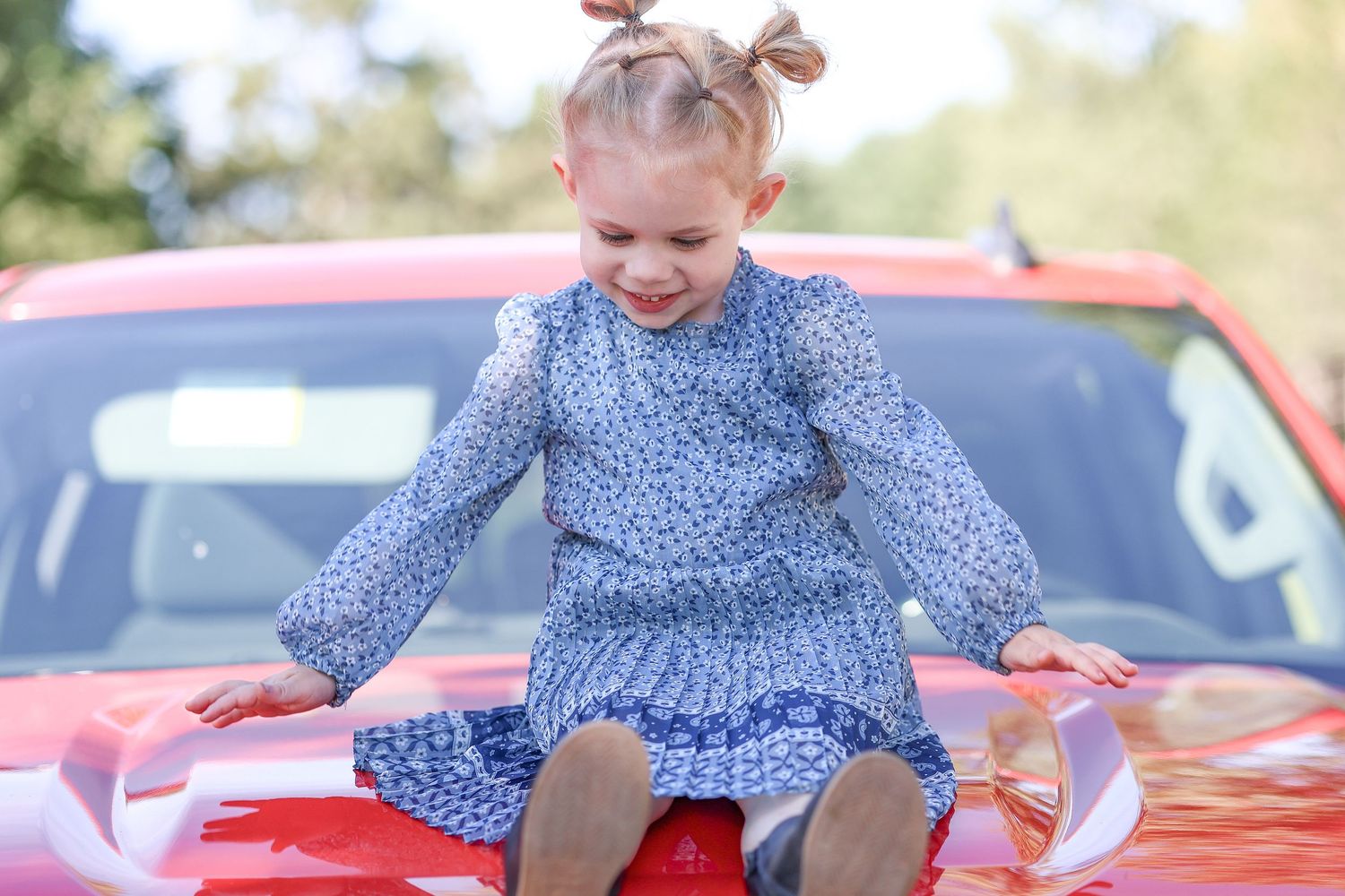 Springfield, IL family photographer captures a granddaughter taking a picture on her grandpas truck during a photo session in Central, IL