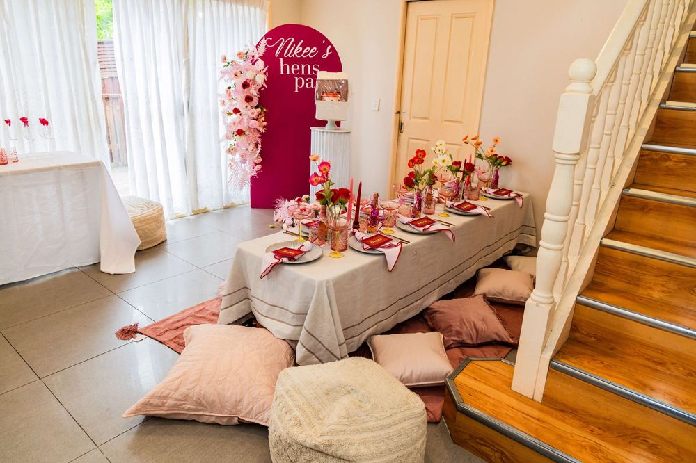 A display of pink and red holiday decor with chic pillow arrangements creates a cozy interior setting at home.